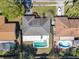 Aerial view of home with a screened pool and boat parked next door in a sunny neighborhood at 1617 E Sandpiper Trl, Casselberry, FL 32707