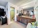 Well-lit main bathroom featuring a vanity with wood cabinets and a mirror at 1617 E Sandpiper Trl, Casselberry, FL 32707