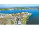 Panoramic aerial showcasing waterfront homes with lush surroundings and tranquil lake at 16728 Bolsena Dr, Bella Collina, FL 34756