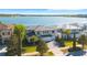 Expansive aerial view showcases lakefront home, manicured landscaping and neighborhood at 16728 Bolsena Dr, Bella Collina, FL 34756