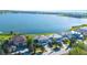 This photo captures a row of lakefront residences, complete with private docks and manicured lawns at 16728 Bolsena Dr, Bella Collina, FL 34756