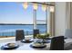 Bright dining room boasts waterfront view, modern lighting, and seating for six at 16728 Bolsena Dr, Bella Collina, FL 34756