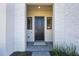 Elegant front door with sidelights and manicured landscaping creates a welcoming entrance at 16728 Bolsena Dr, Bella Collina, FL 34756