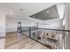 Open hallway overlooking the kitchen, dining room, and living area with wood-look flooring at 16728 Bolsena Dr, Bella Collina, FL 34756