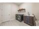 Functional laundry room with modern washer and dryer, shelving, and sink at 16728 Bolsena Dr, Bella Collina, FL 34756