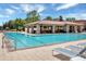 Beautiful swimming pool with a stone pavilion, lounge chairs, and sunny sky at 16728 Bolsena Dr, Bella Collina, FL 34756