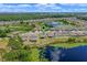 An aerial view of a lakeside home in a residential neighborhood at 17319 Million Lakes Ct, Clermont, FL 34714