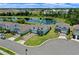 Aerial view of the home showcasing its well-manicured lawn, proximity to a pond, and overall neighborhood layout at 17319 Million Lakes Ct, Clermont, FL 34714