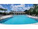 A refreshing community pool featuring ample deck space, lounge chairs, and a clubhouse for residents at 17319 Million Lakes Ct, Clermont, FL 34714