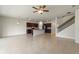 Open-concept living room featuring tile flooring and a kitchen with dark cabinets at 17319 Million Lakes Ct, Clermont, FL 34714