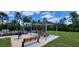 A community picnic area with a grill and tables to enjoy outdoor meals at 17319 Million Lakes Ct, Clermont, FL 34714