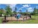 A fenced community playground providing a safe and fun environment for children to play and socialize at 17319 Million Lakes Ct, Clermont, FL 34714