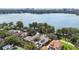 Aerial view of a lakefront home showcasing the city skyline and lush surroundings at 1840 W Fawsett Rd, Winter Park, FL 32789