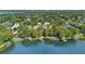 Stunning aerial view of lakefront properties with private boat docks surrounded by lush greenery at 1840 W Fawsett Rd, Winter Park, FL 32789