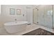 Bright bathroom with a sleek standalone tub and glass shower at 1840 W Fawsett Rd, Winter Park, FL 32789