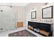 Stylish bathroom featuring dual sinks, marble countertops, and a glass enclosed shower at 1840 W Fawsett Rd, Winter Park, FL 32789