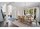 Elegant dining room featuring wood table, chandelier lighting, and natural light with lake view at 1840 W Fawsett Rd, Winter Park, FL 32789