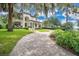 Stately two-story home with a paver driveway and meticulously landscaped front yard at 1840 W Fawsett Rd, Winter Park, FL 32789