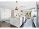 Bright and airy kitchen featuring a large center island, modern appliances, and stylish lighting at 1840 W Fawsett Rd, Winter Park, FL 32789