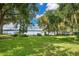 Lush lawn with mature trees, Spanish moss and waterfront views, creating a serene outdoor setting at 1840 W Fawsett Rd, Winter Park, FL 32789