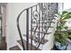 Close up of a classic staircase featuring dark wood steps and an ornate wrought iron railing at 1840 W Fawsett Rd, Winter Park, FL 32789