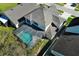 An aerial view shows a screened in pool with a patio and fenced-in yard at 1924 Stonecrest Ct, Orlando, FL 32825