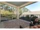 Outdoor balcony includes two chairs and a glass table overlooking a lush wooded area at 1924 Stonecrest Ct, Orlando, FL 32825