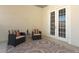 Outdoor balcony includes two chairs and a glass table over a stylish round pattern rug at 1924 Stonecrest Ct, Orlando, FL 32825