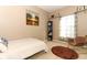 Bedroom with painting and bookshelves and a rocking chair near a window at 1924 Stonecrest Ct, Orlando, FL 32825