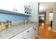 This kitchen countertop features granite, stylish decor, and sleek cabinets for modern storage at 1924 Stonecrest Ct, Orlando, FL 32825