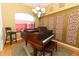 Cozy dining area showcasing a piano, bright natural light, and decorative wall accents at 1924 Stonecrest Ct, Orlando, FL 32825