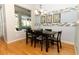 Dining room area featuring hardwood flooring, contemporary table with six chairs and window to patio at 1924 Stonecrest Ct, Orlando, FL 32825