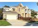 Elegant two-story home boasts a well-manicured lawn and tasteful landscaping at 1924 Stonecrest Ct, Orlando, FL 32825