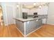 Open kitchen featuring granite countertops, decorative tile backsplash, breakfast bar and hardwood floors at 1924 Stonecrest Ct, Orlando, FL 32825