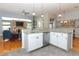 Modern kitchen with granite countertops, white cabinets, stainless steel appliances, and tile flooring near the living room at 1924 Stonecrest Ct, Orlando, FL 32825