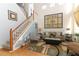 Living area with high ceilings, wood floors, staircase and an ornate art piece on the wall at 1924 Stonecrest Ct, Orlando, FL 32825