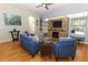 Bright living room with a stone fireplace, flatscreen TV, and lots of natural light through large windows at 1924 Stonecrest Ct, Orlando, FL 32825