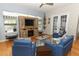 Cozy living room with a stone fireplace, flatscreen TV, and lots of natural light through large windows at 1924 Stonecrest Ct, Orlando, FL 32825