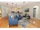 Open-concept living area with a view of the kitchen and modern blue furniture at 1924 Stonecrest Ct, Orlando, FL 32825