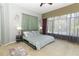 Main bedroom with neutral walls, large windows, and a ceiling fan for comfortable ambiance at 1924 Stonecrest Ct, Orlando, FL 32825