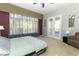 Main bedroom offers outdoor access, sheer drapes, neutral walls, and carpet flooring at 1924 Stonecrest Ct, Orlando, FL 32825