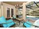 Covered patio area with comfortable seating, perfect for enjoying the pool view and outdoor living at 1924 Stonecrest Ct, Orlando, FL 32825