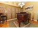 Formal room with vintage piano, unique accent wall, light fixture, area rug and hardwood flooring at 1924 Stonecrest Ct, Orlando, FL 32825