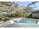 Screened-in pool area with a patio table, chairs, and lush greenery at 1924 Stonecrest Ct, Orlando, FL 32825