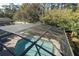 Aerial view of pool with screened enclosure and brick patio, surrounded by mature trees at 1924 Stonecrest Ct, Orlando, FL 32825