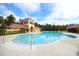 Resort-style community pool with ample deck space, lounge chairs, and lush tropical landscaping at 1924 Stonecrest Ct, Orlando, FL 32825