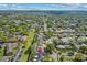 Aerial view of a pin-pointed house located in a neighborhood with a lush green backdrop and clear blue skies at 230 S Ranger Blvd, Winter Park, FL 32792