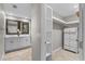 Elegant bathroom with double vanity, framed mirrors, and closet access, combining style and functionality at 230 S Ranger Blvd, Winter Park, FL 32792