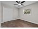 Clean bedroom with hardwood floors, a closet, and a bright window offering a serene view at 230 S Ranger Blvd, Winter Park, FL 32792