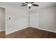 Simple bedroom featuring hardwood floors, a ceiling fan, and a closet, offering a minimalist aesthetic at 230 S Ranger Blvd, Winter Park, FL 32792